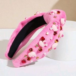Pink velvet headband decorated with stones, hearts and pearls